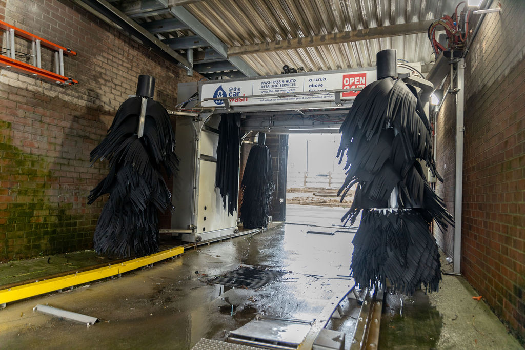 In-bay automatic car wash tunnel with tri-color foam applicators at @ The Car Wash